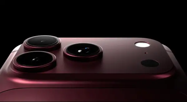 Ciemnoczerwony iPhone 18 Pro Max z trzema obiektywami aparatu i lampą błyskową na czarnym tle.