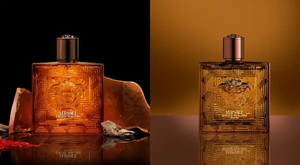 Złota butelka Versace Eros Parfum, otoczona kamieniami i szafranem, emanuje luksusem.