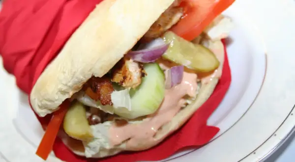 Pyszny kebab w bułce z kurczakiem, warzywami i sosem. Idealny przepis na szybki obiad.