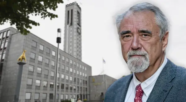 Porträtt av en äldre man med grått skägg och kavaj, framför en byggnad med ett torn. Kanske ett citat från Percy Barnevik.