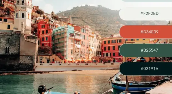 A vibrant Italian coastal town with colorful buildings and boats, showcasing a perfect vacation color palette of blues, reds, and greens.