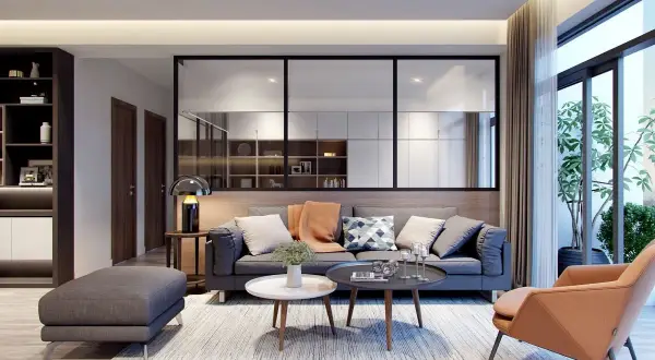 Soggiorno moderno con divano grigio, poltrona color terra e tavolini. Idee originali per arredare casa con stile e comfort.
