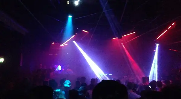 Luci stroboscopiche e fumo in un locale notturno, un'atmosfera da Amnesia Milano recensioni.
