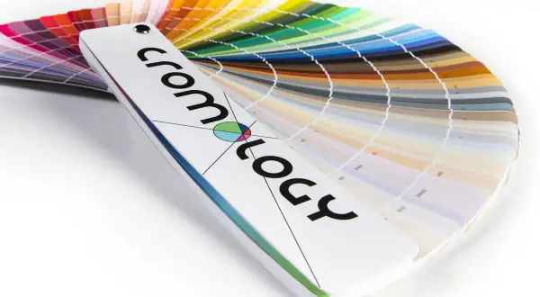Ventaglio di campioni di vernici, una tabella colori che mostra un arcobaleno di tonalità, dal rosso al blu, con il logo "cromology" in primo piano.