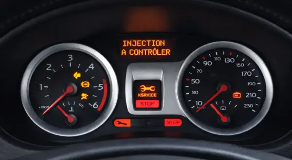 Tableau de bord d'une Clio 3 : voyant injection à contrôler, service et stop allumés. Il est temps de penser à la vidange.
