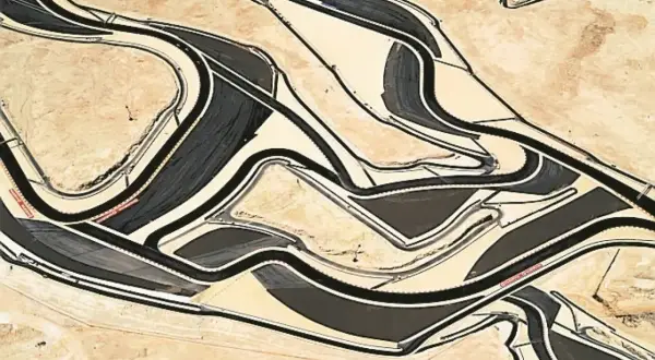 Vista aerea di un circuito automobilistico, un labirinto di asfalto e sabbia, nello stile di Andrea Gursky.