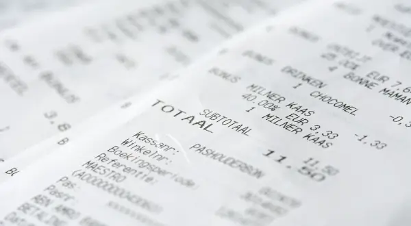 Paragon z zakupami, gdzie numer paragonu jest widoczny. Widoczne pozycje: "TOTAAL", "SUBTOTAAL", "MILNER KAAS", "CHOCOMEL".