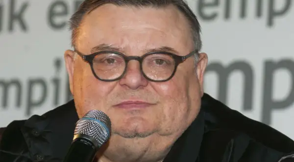 Wojciech Mann, znany z audycji radiowych, w okularach i z mikrofonem. Jego wiek nie jest widoczny na zdjęciu.
