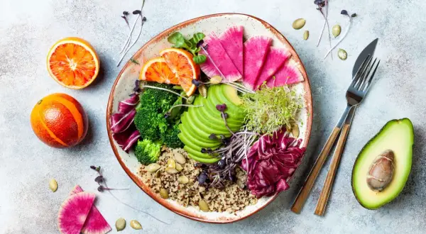 Piatto colorato con quinoa, broccoli, avocado, ravanelli, arance rosse e germogli. Ideale per una dieta priva di scorie cosa mangiare.