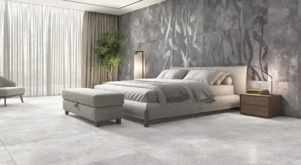 Dormitorio moderno con suelo de porcelánico rectificado, cama confortable y pared decorativa con diseño abstracto.
