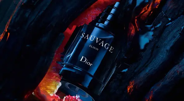 Dior Sauvage Elixir w ciemnym, dramatycznym otoczeniu, otoczony płonącymi, czerwonymi elementami i wodą.