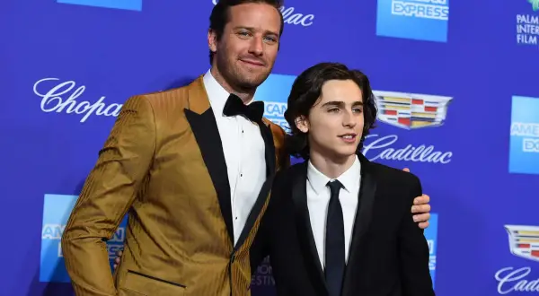 Armie Hammer och Timothée Chalamet på en blå bakgrund med logotyper.