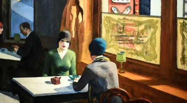 A woman in a green dress and black hat sits at a table, a small teapot before her. Hopper's "Chop Suey" captures a moment of quiet contemplation.