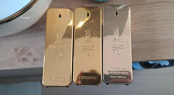 Trzy flakoniki perfum Paco Rabanne 1 Million 100ml w złotych i srebrnych odcieniach.