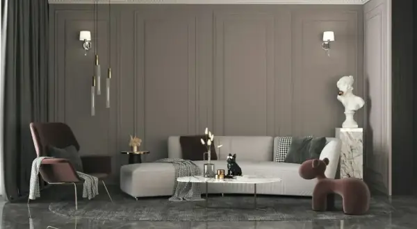 Nowoczesny salon z szarą kanapą, designerskim fotelem i okrągłym stolikiem. Elegancki styl wnętrz podkreślają złote lampy i marmurowe detale.