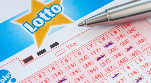 Kupon Lotto z zaznaczonymi liczbami, gotowy do gry w multi systemy na 3 liczby. Długopis czeka na kolejne wybory.