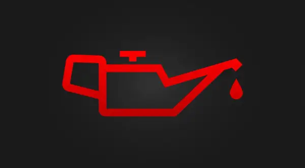 Luz de advertencia roja de un motor con exceso de aceite. Indica un problema grave que requiere atención inmediata.