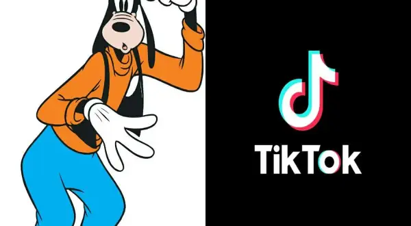 Goofy w pomarańczowej bluzie i niebieskich spodniach, obok logo TikTok. Goofy ahh, jakby tańczył do viralowego trendu.