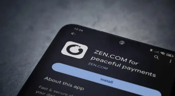 Ekran telefonu z aplikacją ZEN.COM, która oferuje "peaceful payments". To Twój nowy, spokojny bank.
