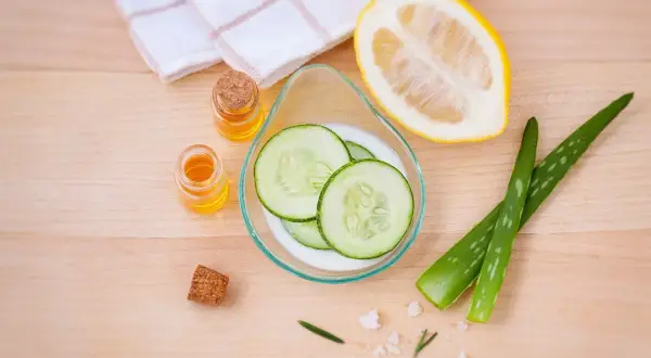 Natürliche Zutaten für ein Beauty-Tag zuhause: Gurkenscheiben, Aloe Vera, Zitrone und Öle.