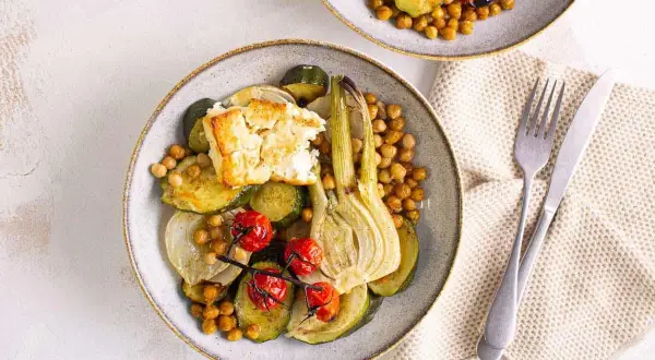 Assiette de légumes rôtis (courgettes, fenouil, tomates) avec pois chiches et feta. Une recette végétarienne inspirée d'une vieille recette de poisson.