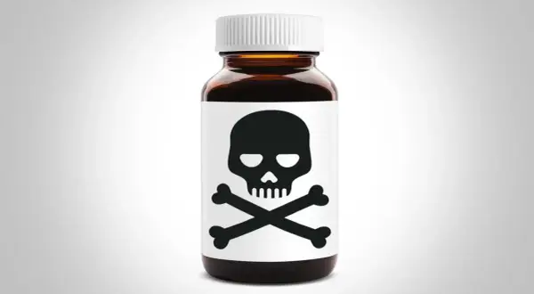 Brun medicinflaska med dödskallesymbol. Kan orsaka hallucinationer av medicin.