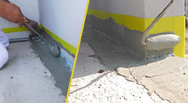 Arbeiter versiegeln Fugen der Terrasse mit einer grauen Masse. Gelbes Klebeband schützt die Wand.