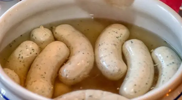 Biała kiełbasa w bulionie, gotowa do podania. Idealny przepis na tradycyjne danie.