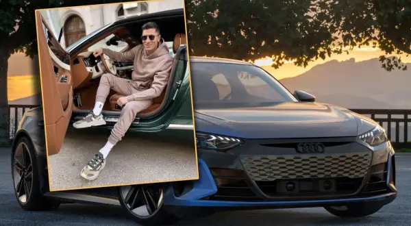 Robert Lewandowski w stylowym dresie i modnych sneakersach pozuje przy luksusowym samochodzie. To jedne z jego wymarzonych samochodów.