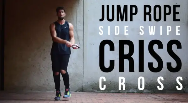 A man in athletic wear performs a jump rope routine, showcasing a "Criss Cross" move. He's as agile as Mike Tyson in his prime, mastering the jump rope.