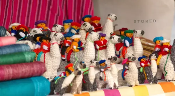 A collection of charming, handmade llama stuffed animals, showcasing creative stuffed animal storage ideas.