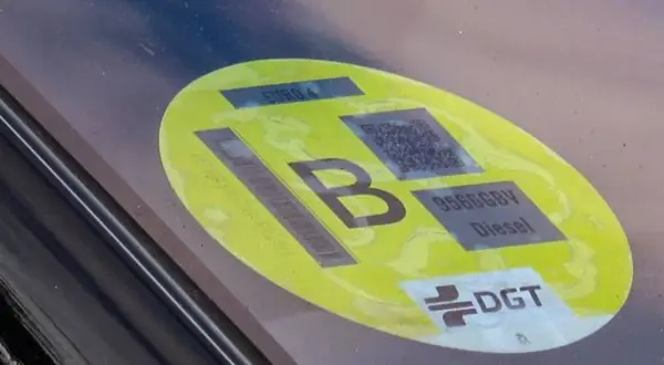 Etiqueta b de la DGT en un parabrisas, indicando EURO 4 y motor diésel.