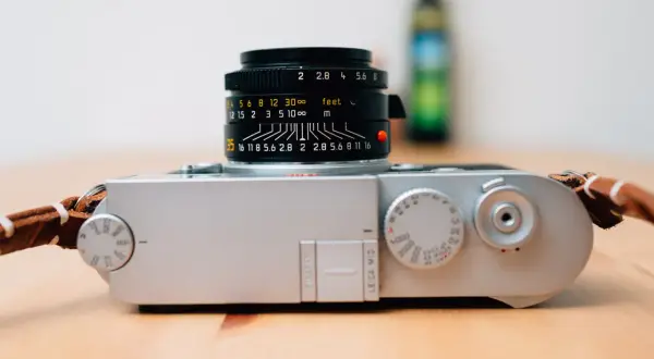 A silver Leica M10 camera with a black Leica Summicron lens attached, ready for capturing timeless moments.
