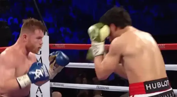 Boxers in a ring, one in a classic Mexican style boxing stance, throwing a punch.