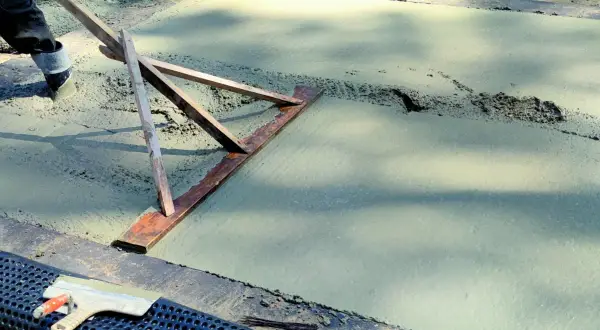 Chudziak wyrównuje świeży beton.