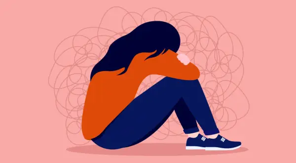 En person sitter hopkrupen, omgiven av trassliga linjer som symboliserar hur det känns när man undrar vad betyder toxic i relationer.