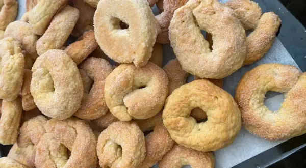 Un mucchio di taralli salati al vino bianco friabili, cosparsi di zucchero, pronti per essere gustati.