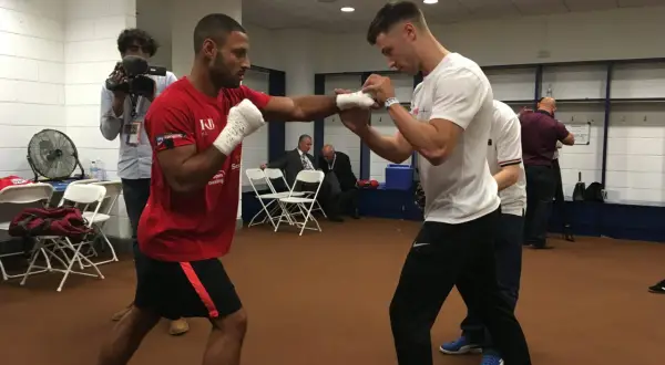 Boxers practice their moves, showing how to prepare for a fight. A cameraman films the training session.