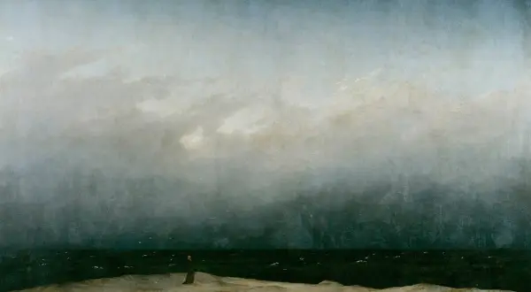 The wanderer painting depicts a solitary figure on a desolate shore, gazing out at a turbulent sea under a dramatic, cloudy sky.