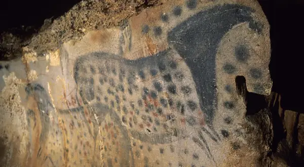 Peintures rupestres des grottes du Pech Merle : un cheval tacheté noir et rouge, une œuvre d'art préhistorique.