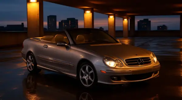 Srebrny kabriolet Mercedes CLK W209 na mokrym parkingu. Dane techniczne tego modelu są imponujące.