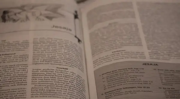En öppen bibel med texten "Jesaja" synlig. En bok i bibeln som berättar om Guds budskap.