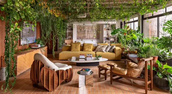 A living room embracing organic architecture, with lush plants cascading from the ceiling and filling the space, creating a vibrant, natural sanctuary.