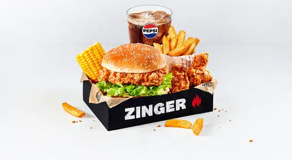 Pyszny Zinger Box z burgerem, kurczakiem, frytkami, kukurydzą i Pepsi. Idealny zestaw, by zaspokoić głód i sprawdzić zinger kcal.