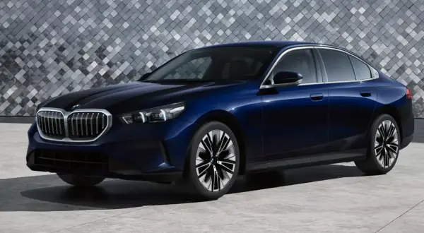 Eleganckie, granatowe bmw 520 z nowoczesnym designem, stojące na tle geometrycznej ściany.