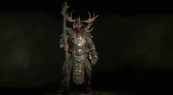 Potężny druid z Diablo 4, z porożem na hełmie i kosturem, gotowy do walki. Idealny diablo 4 druid build pl.