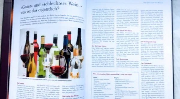 Flaschen mit Wein und Gläser, die eine Wein-Bewertung illustrieren.