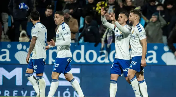 Jugadores de fútbol del Zaragoza celebran en el campo.