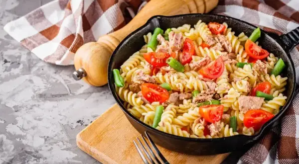 Pyszna kolacja bez mięsa: makaron fusilli z tuńczykiem, pomidorkami i fasolką szparagową w patelni.