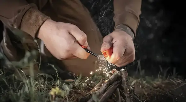 Rozpalanie ogniska krzesiwem to podstawa bushcraftu. Wiedza, jak to zrobić, jest kluczowa.